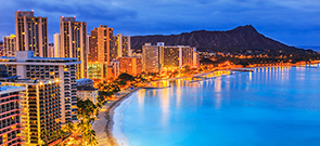 cityscape of Oahu on the beach with a mountain in the background