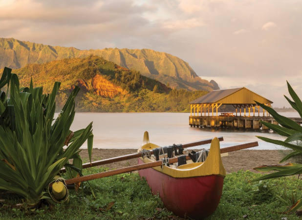 A red and yellow Hawaiian outrigger canoe.